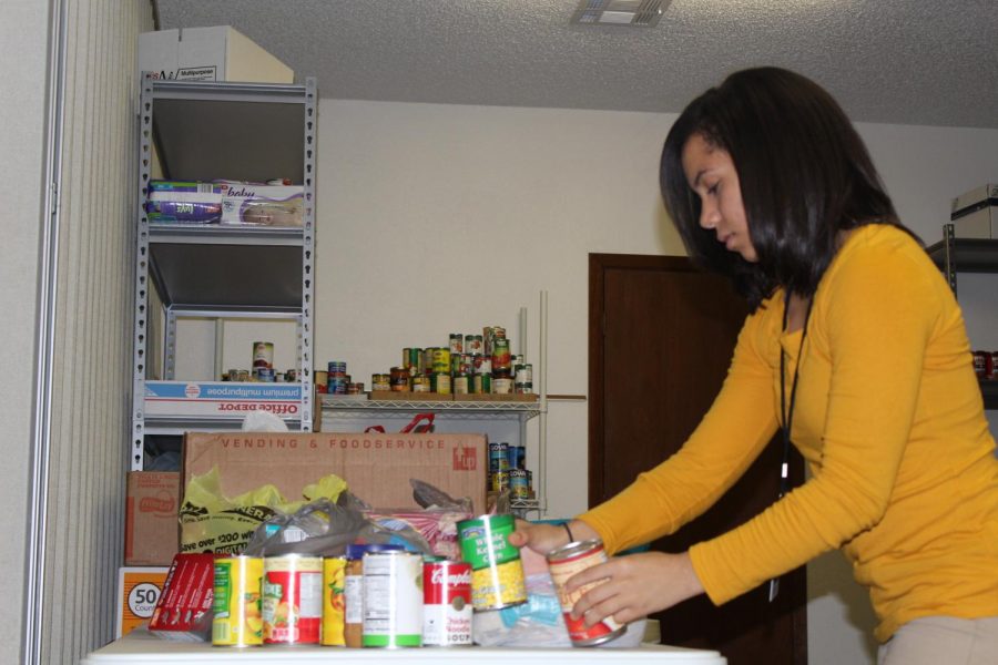 Emily Ventura helps organize the food donations at the Lott pantry. 