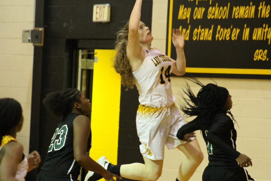 Clara Coker goes up for a lay-up during the district opener against Rappaport. 
