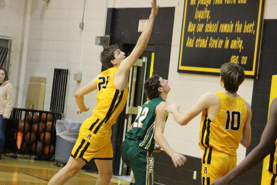 Brady Hering goes for the block during the district match-up with Moody. 