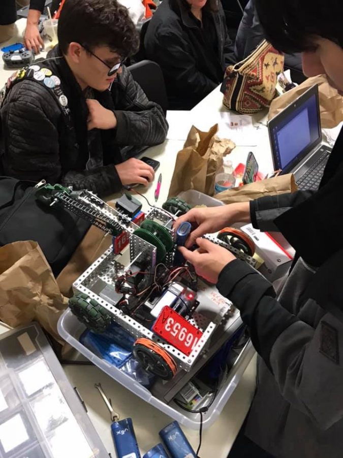 Students fine tune their robot at competition. 