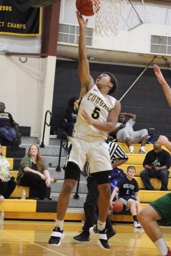 Breon Lewis goes up for a lay-up against Bluff Dale during the Cougar Classic tournament. 