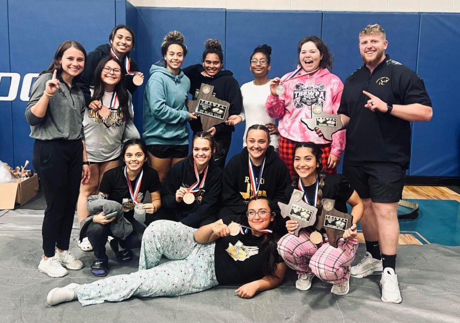 The girls team poses after winning first place at the regional meet. 