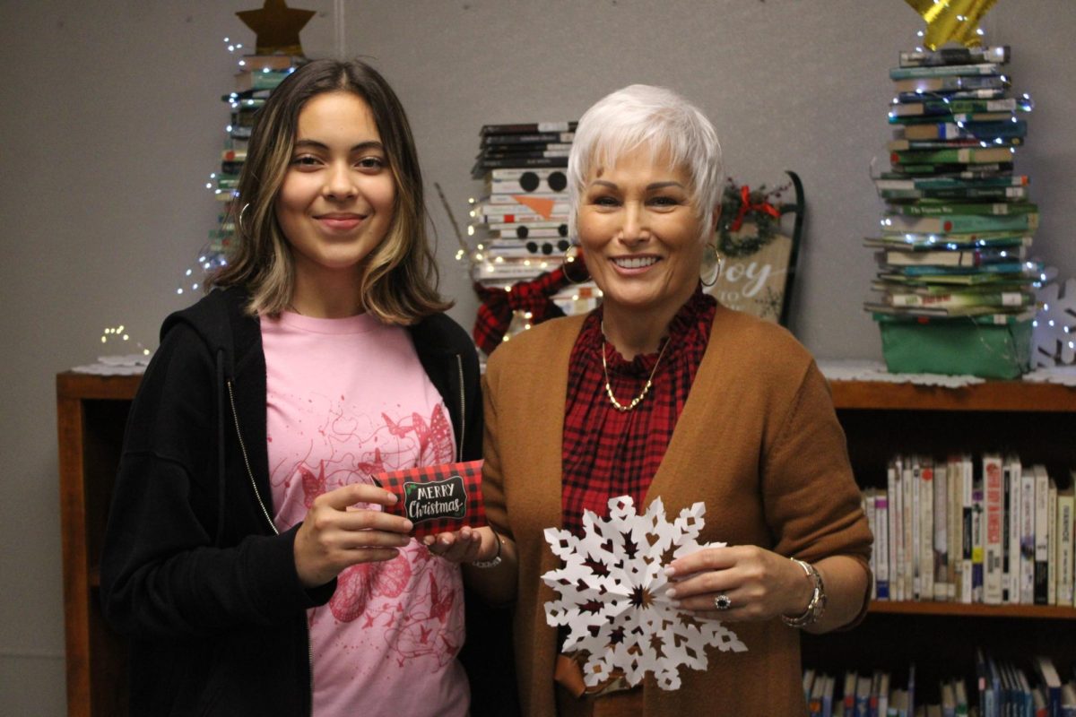 Joselynn Pratt poses with Ms. Meeker after having won the first-ever Snowflake contest before Thanksgiving. 