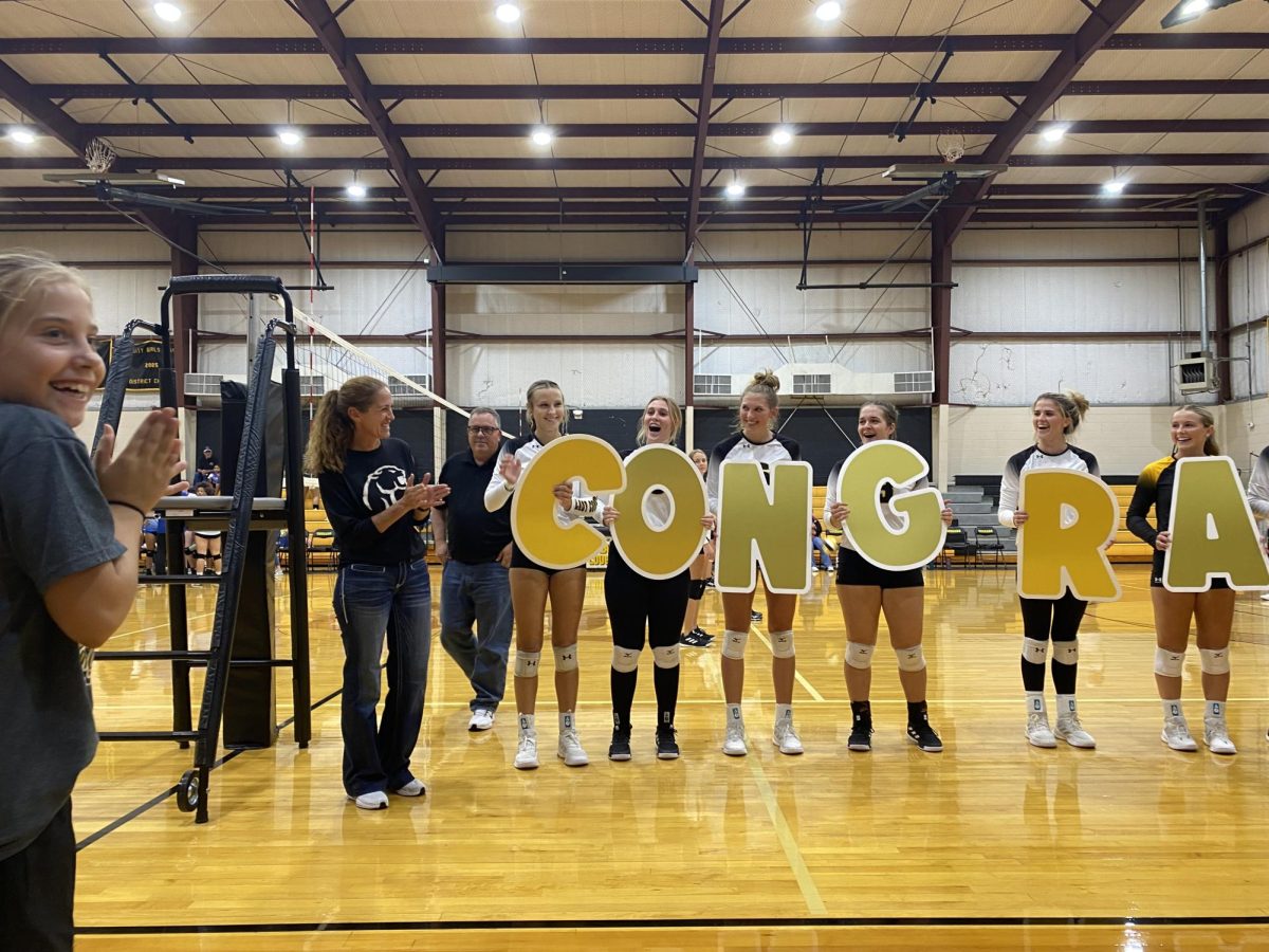 Coach Spencer enjoys a celebration with the varsity team after reaching her 400th win. 