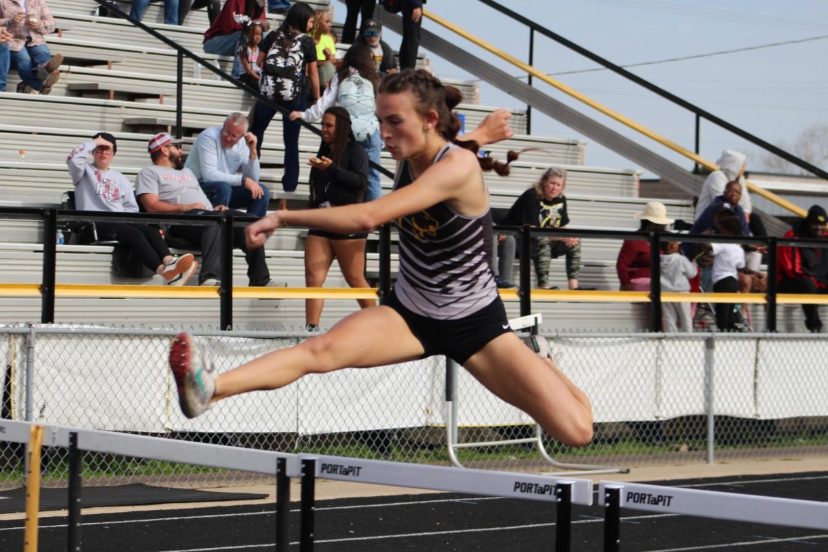 Alexis Hines clears a hurdle in the 300m hurdle race. Hines broke the long standing school record, set back in 2000.  