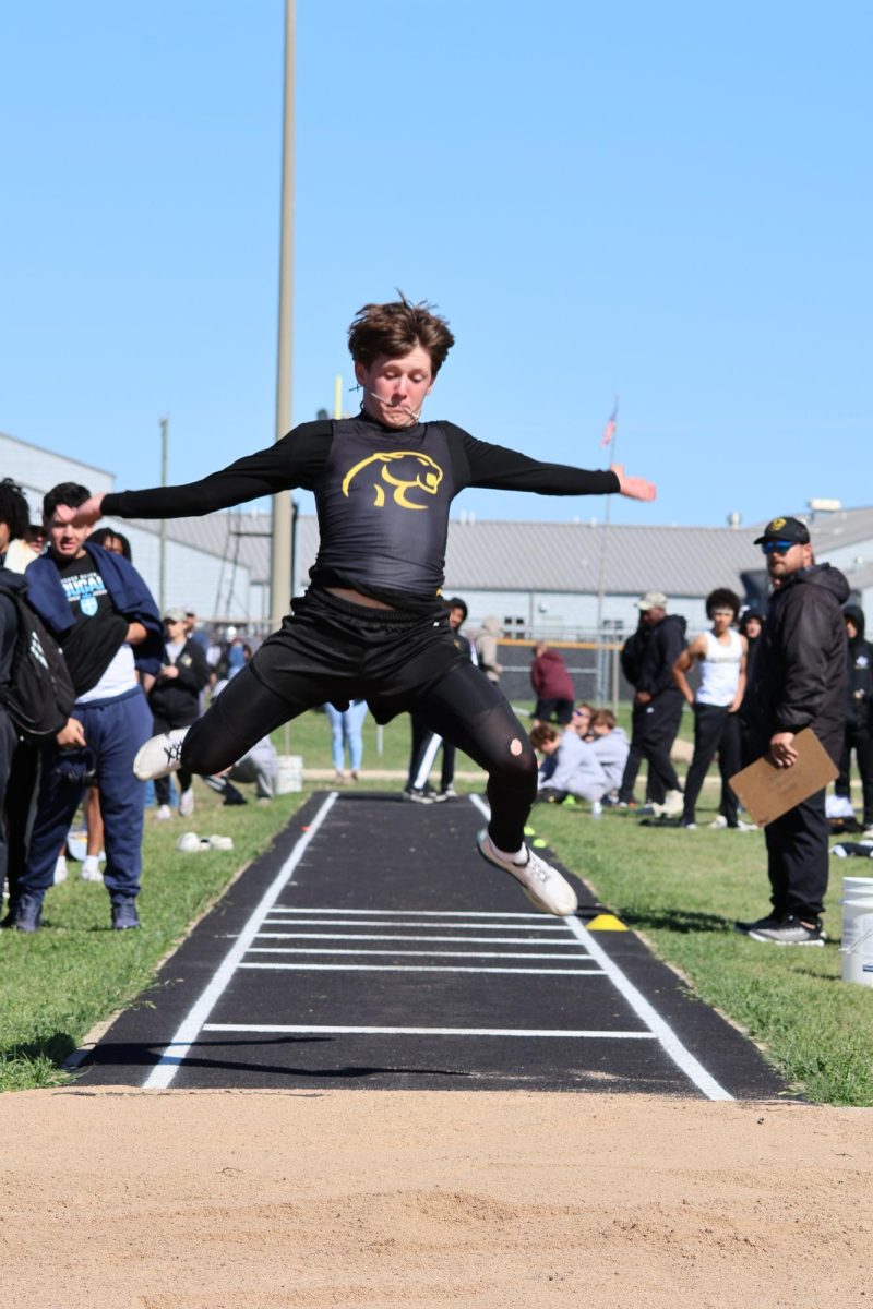 Kaleb Chaney participates in the long jump. 