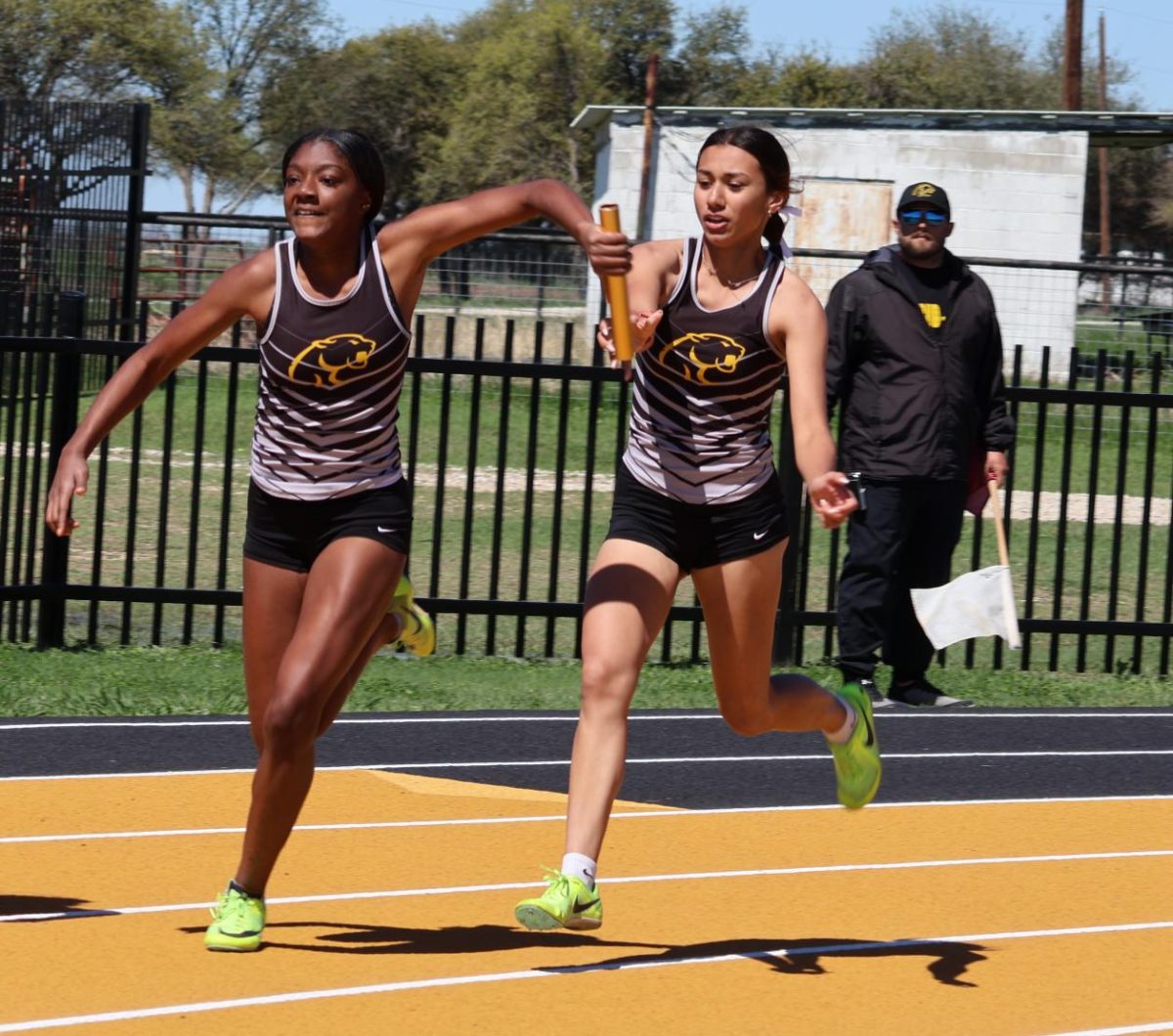 A'Laya Cavitt takes the baton from Emery Easter during the 4x100m Relay at the Cougar Relays held at RL. 