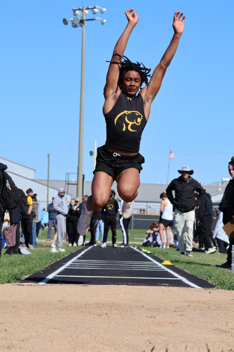 Ta'Marion Travis jumps in the triple jump during the Cougar Relay meet earlier in the season. 